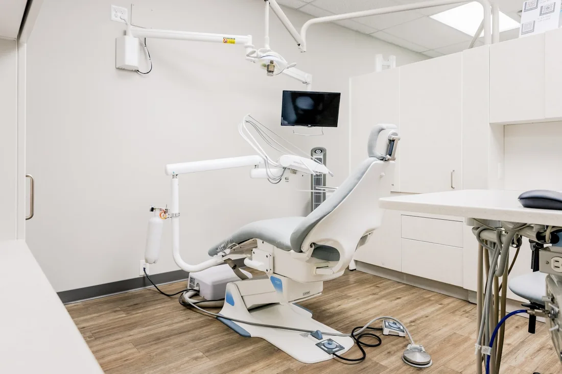 A bright, uncluttered dental treatment room used as a design reference.